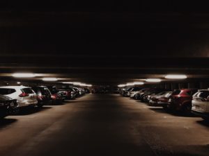 Cars in a dark parking garage.
